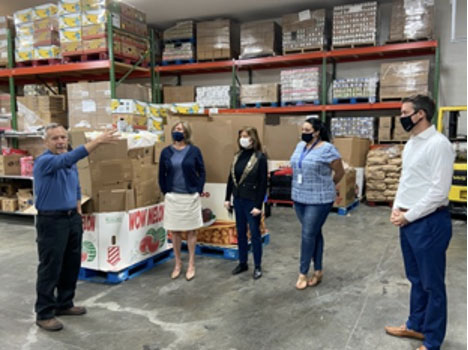 Charter employees and State Rep. Deanna Frazier tour the food bank at God’s Outreach in April, 2021